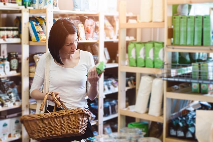 Woman choosing products in ecological shop with healthy